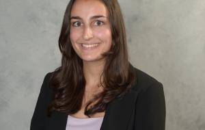 Woman smiling and wearing black blazer