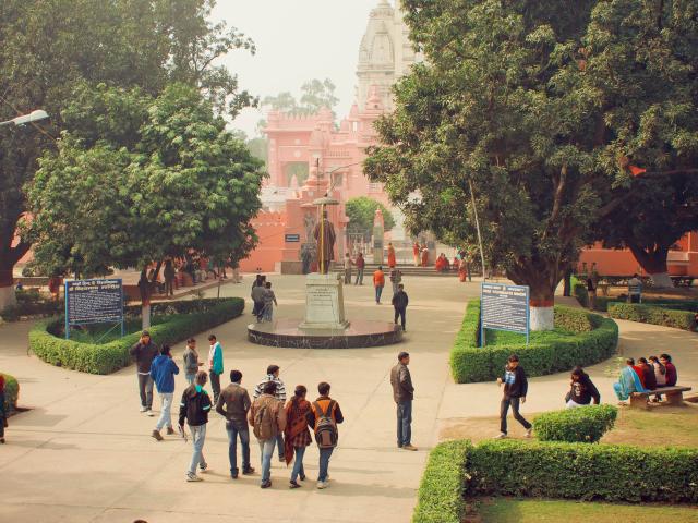 A group of students walking through a university campus in India