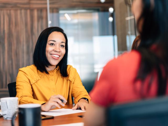 Woman speaking to client at office over the table