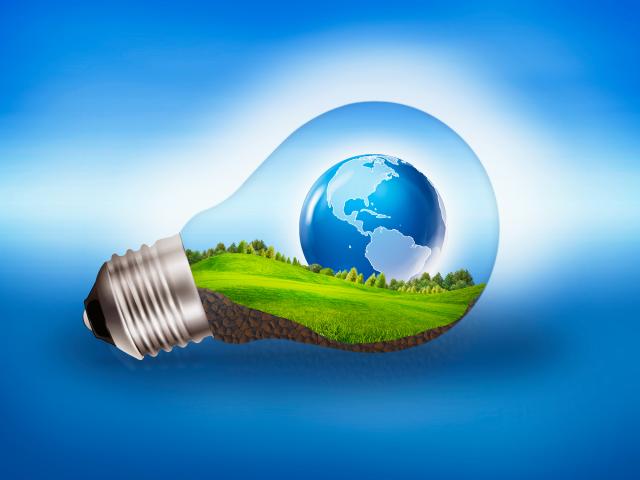 Graphic showing a globe and green landscape inside a transparent light bulb on a blue background