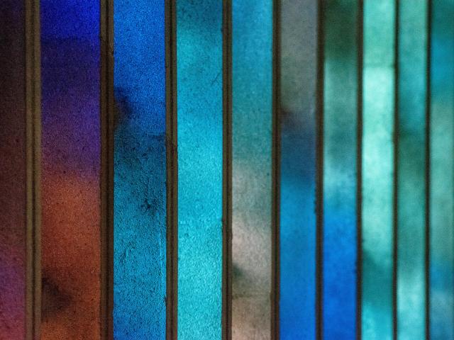 Stained glass varying in shades of blue and green