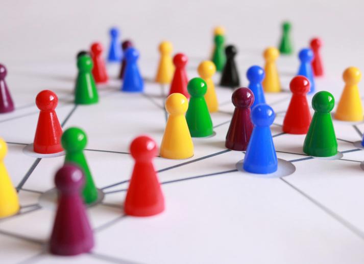 Colorful plastic game pieces on a white board with connected lines