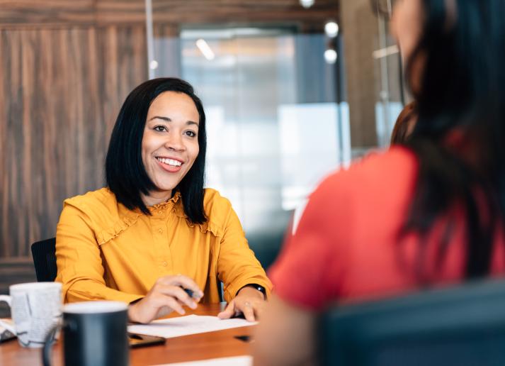 Woman speaking to client at office over the table