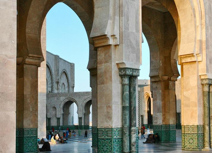 People sitting and walking in a historical site 