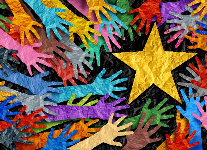 Colorful paper hands reaching for yellow paper star