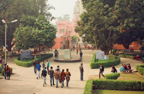 A group of students walking through a university campus in India