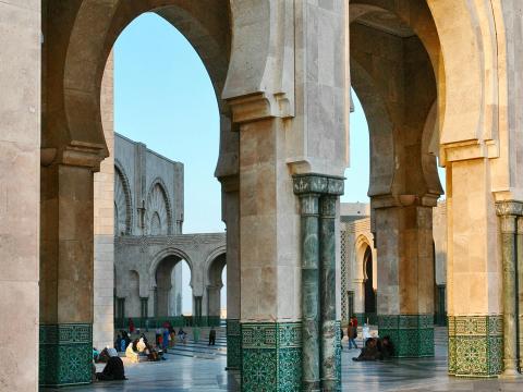 People sitting and walking in a historical site 